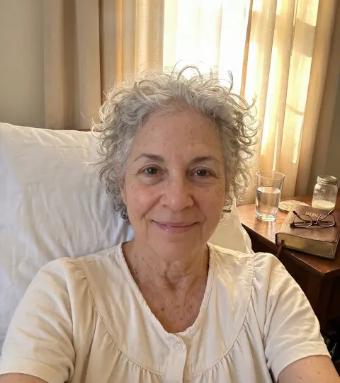 Dorothy, after — sitting up, face relaxed, morning light behind her