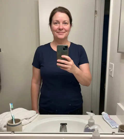Linda, after — calm and at ease, in a navy t-shirt